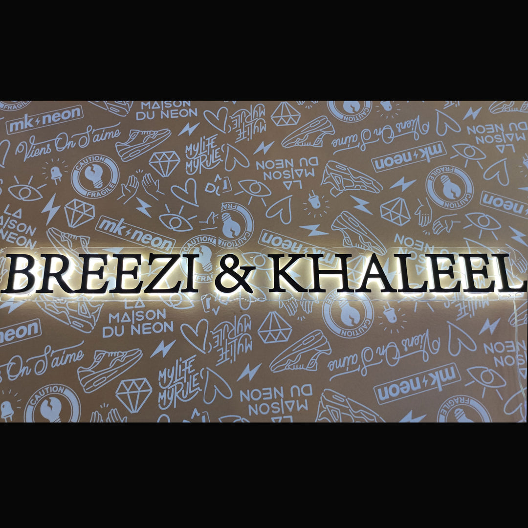 reversed neon backlit breezi khaleel black font